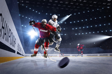 Obraz na płótnie Canvas Hockey players shoots the puck and attacks