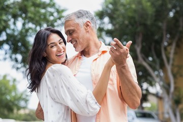 Fototapeta premium Woman with man dancing in city