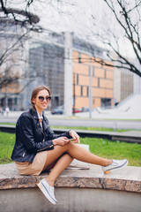 Beautiful woman sitting on the bench, talking on her phone