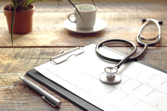 Doctor Workplace With A Stethoscope At Wooden Table