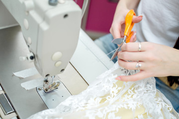 girl seamstress sew on the sewing machine