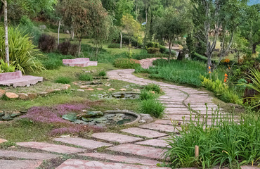 Pathway with beautiful flowers on side in the garden