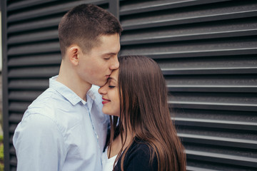 Lovely couple standing on the street and kissing