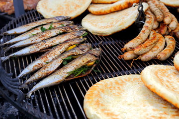 Preparing food on the grill outside.