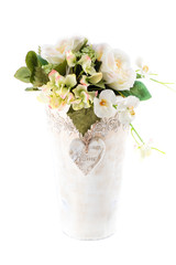 beautiful pot of delicate flowers on a white background