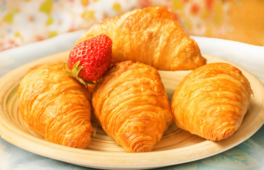 Fresh croissants on plate