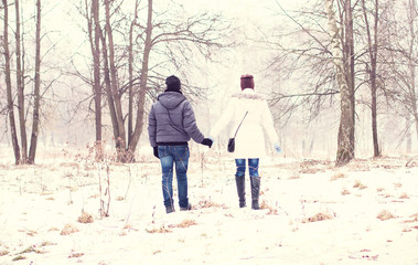 Fototapeta na wymiar Young couple in winter park, woods, resting enjoying walk, happy family, idea style concept love relationships, clothes hats