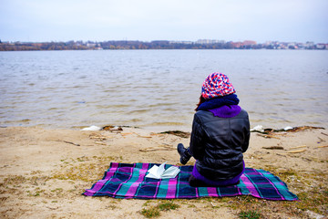 A woman on the old beach starring at the restless Sea