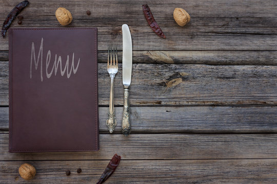 Vintage restaurant menu on a rustic wood background