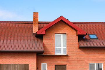 chimney on the roof of the house against the blue sky