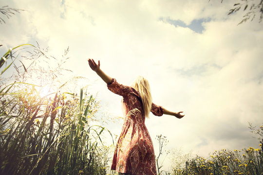 young woman enjoying nature in the middle of a meadow