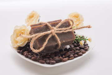 organic soap with a flowers on white wood background
