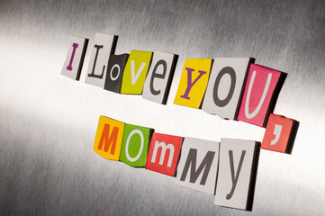 Obraz premium Mothers day message of color magazine letter clippings on metal background. I love you mom or mommy. Selective focus