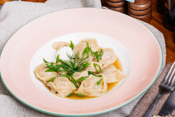Boiled prepared homemade russian dumplings or pelmeni with beef
