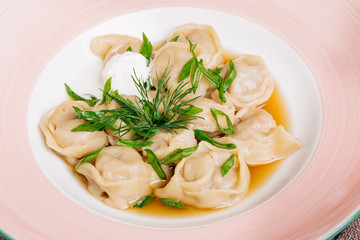 Boiled prepared homemade russian dumplings or pelmeni with beef
