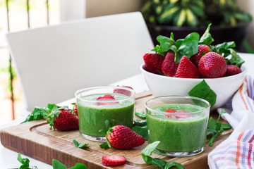 Green spinach smoothie with strawberry