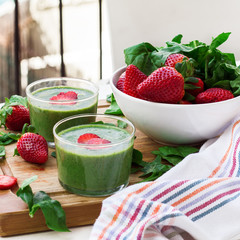 Green spinach smoothie with strawberry