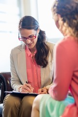  Beautiful young woman discussing with psychologist