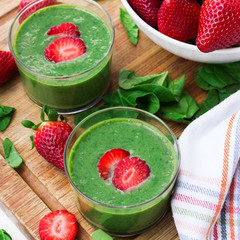 Green spinach smoothie with strawberry