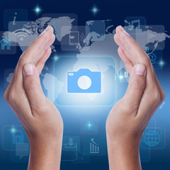 Hand showing camera icon symbol on screen. business concept