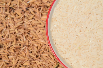 rice grains in bowl on rice background