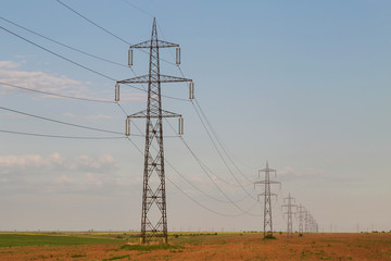 High voltage electric poles on a field
