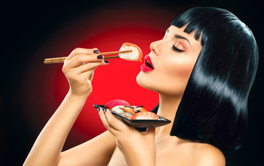 Sushi. Fashion art portrait of beauty model girl eating sushi