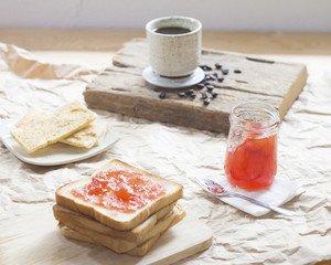 Bread with and homemade jam in on wooden table, closeup.
