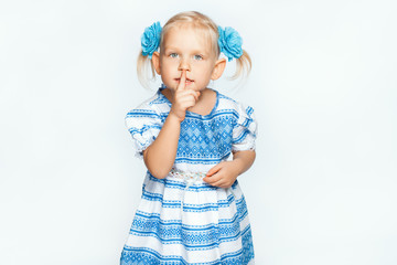 Beautiful baby girl on a white background making shh