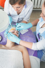 Beautiful woman in spa salon receiving epilation or correction e