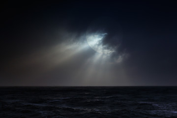 Overcast sea full moon night