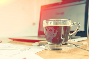 coffee cup on wooden table, soft focus
