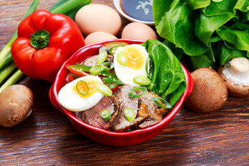 Duck noodles with egg, vegetables and duck meat in bowl