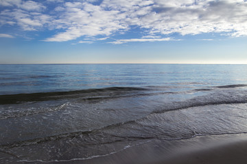 Fototapeta na wymiar Seascape with stratocumulus clouds over horizon line