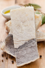 dry salted cod fish on brown wooden background