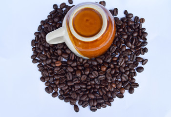Coffee cup on coffee beans on white background