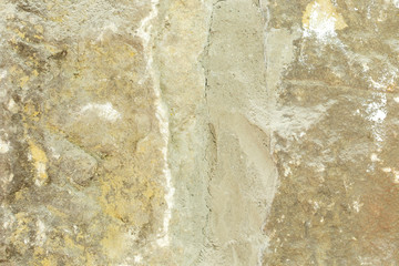 Old moldy stone wall with concrete.