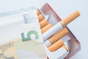Open pack of cigarettes isolated, five euro