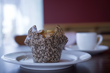 hot coffee and fresh Muffin on wooden table