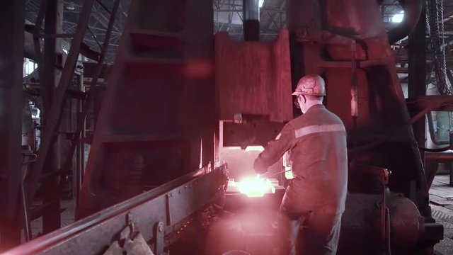The blacksmith works at the forge press. HD.