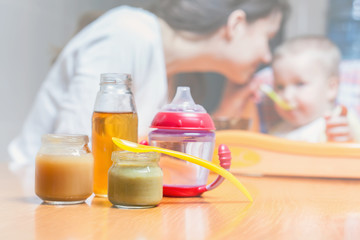 Mom feeds the baby pure. Juice. Drink