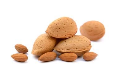 Heap of fresh almonds in shells isolated on white background