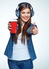 Beautiful girl listening music with coffee glass.