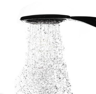 Water drops from shower head in bathroom on white background