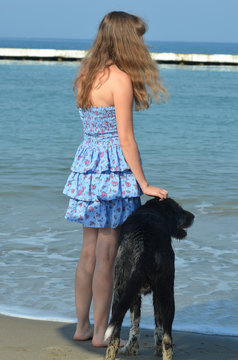 Girl In Dress With Dog On The Shore Of The Mediterranean Sea, Turkey