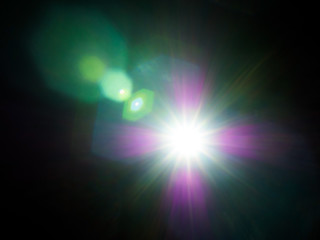 Obraz premium Lens flare of strong light source in the dark