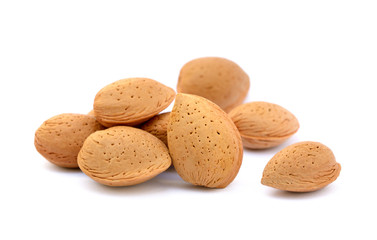 Heap of fresh almonds in shells isolated on white background
