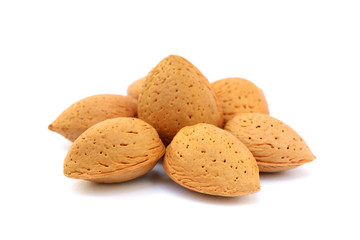 Heap of fresh almonds in shells isolated on white background