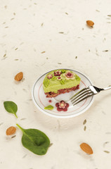 Raw vegan spinach cake with the raw marzipan flowers and leaves