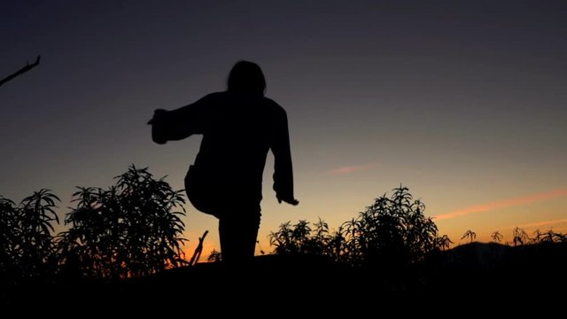 Young woman climbing on the hills, and enjoy sunset, super slow motion
